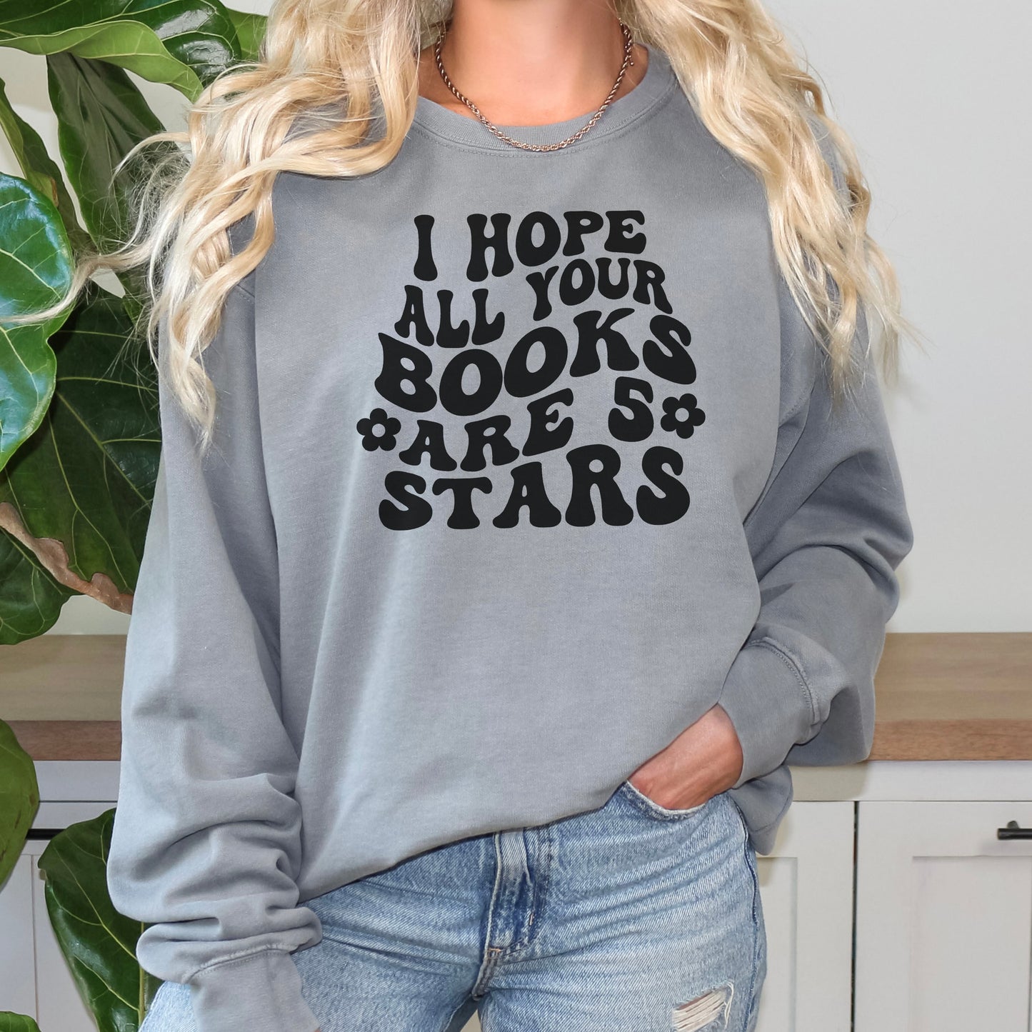 Cozy bookish sweatshirt featuring a bold, retro-style "I Hope All Your Books Are 5 Stars" design. Modeled in various colors, this soft and stylish sweater is perfect for book lovers who enjoy comfy, literary-inspired fashion while reading or lounging.