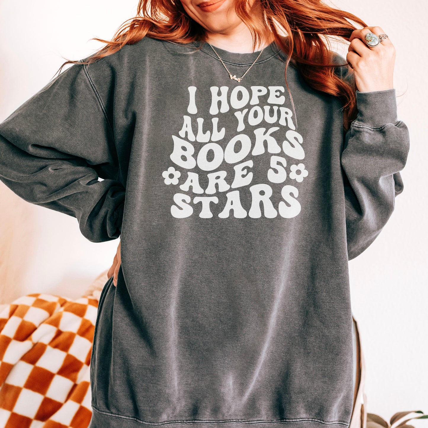 Cozy bookish sweatshirt featuring a bold, retro-style "I Hope All Your Books Are 5 Stars" design. Modeled in various colors, this soft and stylish sweater is perfect for book lovers who enjoy comfy, literary-inspired fashion while reading or lounging.